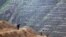 FILE - Man-made terraces are seen on a hillside in the Loess Plateau, in China's northern Shaanxi province, Oct. 26, 1995. Archeologists recently dicovered artifacts in the area that suggest that human-like creatures trekked out of Africa much earlier tha