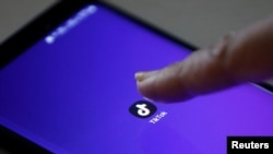 FILE - The logo of the TikTok app is seen on a mobile phone, Feb. 21, 2019. 