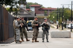 Members of the Wisconsin National Guard stand outside Kenosha County Public Safety Building, over a week since Black man Jacob Blake was shot by police and a day before a visit by U.S. President Donald Trump in Kenosha, Wisconsin, Aug. 31, 2020.