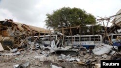 A view shows the damaged structures and school buses at the scene after a car exploded in a suicide attack near Mucassar primary and secondary school in Hodan district of Mogadishu, Somalia, Nov. 25, 2021.