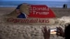 A person takes a picture of a sand sculpture depicting Republican Donald Trump after he won the U.S. presidential election, at Puri beach, in the Eastern State of Odisha, India, Nov. 6, 2024.