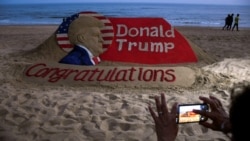 A person takes a picture of a sand sculpture depicting Republican Donald Trump after he won the U.S. presidential election, at Puri beach, in the Eastern State of Odisha, India, Nov. 6, 2024.