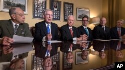 Senate Judiciary Committee Chairman Chuck Grassley, R-Iowa, Senate Majority Leader Mitch McConnell, R-Ky., Senate Finance Committee Chairman Orrin Hatch, R-Utah, talk to reporters in Washington, Nov. 9, 2017.