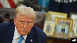 President Donald Trump speaks to reporters as he signs executive orders in the Oval Office of the White House, Jan. 31, 2025, in Washington. 