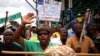 FILE - A miner gestures as they gather at Wonderkop stadium outside the Lonmin mine in Rustenburg, northwest of Johannesburg, Jan. 30, 2014.