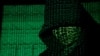 (FILE) A Projection of cyber code on hooded man is pictured in this illustration picture.