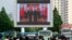 지난 2019년 6월 북한 평양역 광장에 설치된 대형 화면에서 북한 김정은 국무위원장이 중국에서 시진핑 주석 부부와 만난 소식이 나오고 있다.
