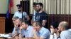 In this photo taken on Sunday, June 16, 2019, Abdulmumin Gadzhiev, the religious affairs editor of the independent weekly Chernovik, stands in a cage in a court room in Makhachkala, the Caspian Sea province of Dagestan, Russia, Sunday, June 16, 2019…