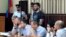 In this photo taken on Sunday, June 16, 2019, Abdulmumin Gadzhiev, the religious affairs editor of the independent weekly Chernovik, stands in a cage in a court room in Makhachkala, the Caspian Sea province of Dagestan, Russia, Sunday, June 16, 2019…