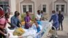 Medical personnel carry a wounded person on a stretcher to be airlifted to the Turkish capital for treatment after they were injured in Saturday's car bomb blast in Mogadishu, Somalia, Dec. 29, 2019. 