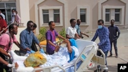 Medical personnel carry a wounded person on a stretcher to be airlifted to the Turkish capital for treatment after they were injured in Saturday's car bomb blast in Mogadishu, Somalia, Dec. 29, 2019. 