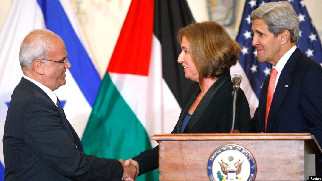 El jefe negociador palestino Saeb Erekat y la ministra de Justicia israelí, Tzipi Livni, se saludan tras las primeras declaraciones conjuntas, junto al secretario de Estado, John Kerry.
