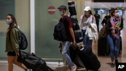 FILE: Passengers arrive at Barcelona Airport, Spain, June 30, 2020.