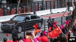 FILE —Supporters cheer as the motorcade of China's President Xi Jinping passes as he arrives to his hotel near the Asia-Pacific Economic Cooperation (APEC) summit headquarters on November 14, 2023 in San Francisco, California.