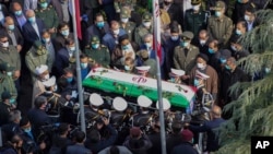 Military personnel carry the coffin of Mohsen Fakhrizadeh, an Iranian scientist killed on Friday, at a funeral ceremony in Tehran, Nov. 30, 2020.