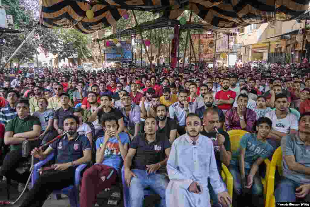 Men gathered in the streets to watch the World Cup, blocking some streets in Cairo suburbs, June 15, 2018.