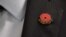 American Legion spokesman Joe Plenzler wears a National Poppy Day pin on his lapel at the Pentagon in Washington, May 22, 2017.