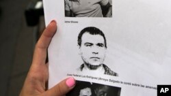 A reporter holds a picture of Antonio "Jaime" Stiusso, one of the country's most enigmatic spy chiefs, outside the prosecutor's office in Buenos Aires, Feb. 5, 2015. 