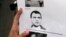 A reporter holds a picture of Antonio "Jaime" Stiusso, one of the country's most enigmatic spy chiefs, outside the prosecutor's office in Buenos Aires, Feb. 5, 2015. 