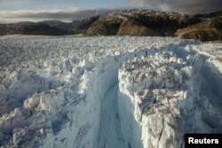 FILE - A large crevasse forms near the calving front of the Helheim glacier near Tasiilaq, Greenland, June 22, 2018.