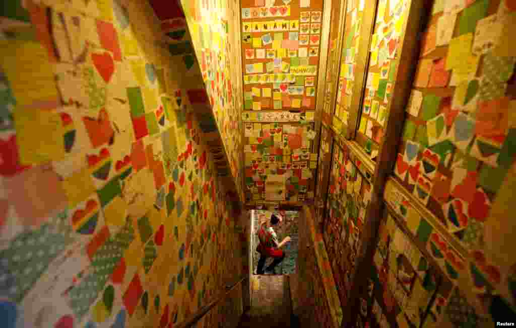 An employee is seen at the Note Coffee shop where the walls,ceiling and chairs are covered with post-it notes from people around the World, in Hanoi, Vietnam.