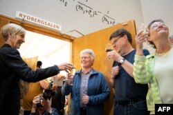 French-Swedish physicist Anne L'Huillier, who is one of this year's Nobel laureates in physics, celebrates with students and colleagues at Lund University, in Lund on October 3, 2023. (Photo by Ola TORKELSSON / TT NEWS AGENCY / AFP)
