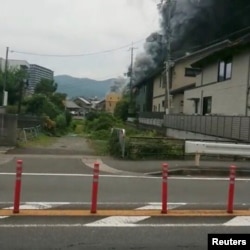 Social media video grab of smoke billowing from a fire at the Kyoto Animation studio in Kyoto