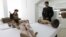 A police officer stands near art pieces during a news conference at Ecuador's National Cultural Heritage Institute (INPC) in Quito, Feb. 3, 2016. 
