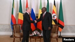 Russian President Vladimir Putin shakes hands with South African President Cyril Ramaphosa during a meeting with African leaders in Saint Petersburg , June 17, 2023.