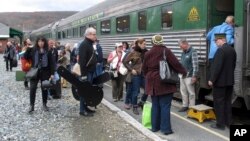 In this Saturday Nov. 7, 2015 photo, travelers board the Roots on the Rails music train in Bellows Falls, Vt. The special train made its first East Coast Trip between Bellows Falls and Rutland, Vt.