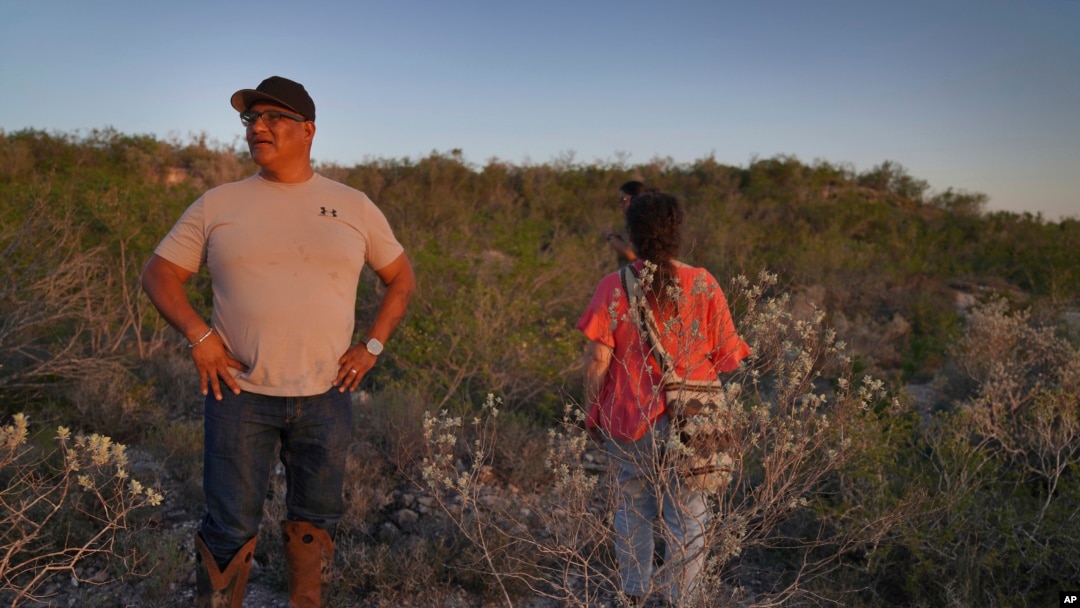 Sandor Iron Rope, Oglala Lakota tribe member and president of the Native American Church of South Dakota, left, and Miriam Volat, executive director of the Indigenous Peyote Conservation Initiative, look for peyote in Hebbronville, Texas, March 26, 2024. 