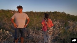 Sandor Iron Rope, Oglala Lakota tribe member and president of the Native American Church of South Dakota, left, and Miriam Volat, executive director of the Indigenous Peyote Conservation Initiative, look for peyote in Hebbronville, Texas, March 26, 2024. 