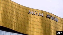 (FILES) This file photo taken on March 5, 2019 shows signage for the MGM casino resort building in Macau. - Macau casino stocks plunged by more than a quarter on September 15, 2021, as the city known as China's Las Vegas kicks off a public…