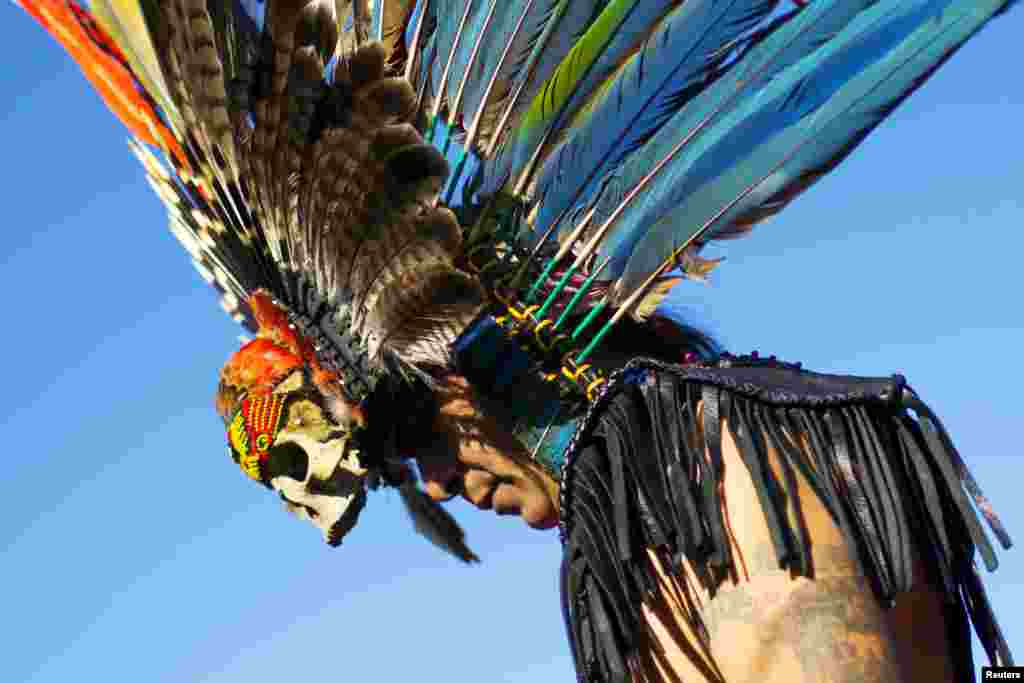 A reveler gets ready to dance during a &quot;pow-wow&quot; celebrating the Indigenous Peoples Day Festival in Randalls Island, New York, Oc. 11, 2015. The festival is held as a counter-celebration to Columbus Day and is to promote Native American culture and history.