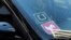 FILE - A ride share car displays Lyft and Uber stickers on its front windshield in downtown Los Angeles, Calif., Jan. 12, 2016.