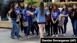  A bioengineering student leads prospective college-bound high school seniors on a campus tour in Los Angeles. Fewer California high school students have been offered admission to University of California campuses for the fall, officials reported