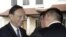 In the first high-level meeting between China and Vietnam since China's deployment of a giant oil rig off the Vietnamese coast last month increased tensions between the two, Chinese State Councilor Yang Jiechi, left, is greeted by a hotel executive as he 