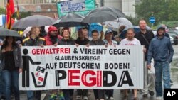 FILE - Participants of a rally called 'Patriotic Europeans against the Islamization of the West' (PEGIDA) demonstrate in Chemnitz, eastern Germany, August 17, 2015. 