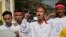 Min Min, second right, rights activist and political prisoner who was released from Insein Prison, shouts slogans demanding the release of all remaining political prisoners outside the prison in Yangon, Myanmar, Jan. 22, 2016. 