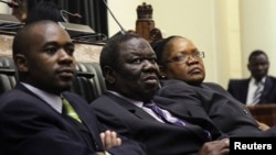 Zimbabwe VP Joice Mujuru (R), Prime Minister Morgan Tsvangirai (C) and member of the House of Assembly of Zimbabwe for Kuwadzana Nelson Chamisa attends the presentation of the Final Draft of the Constitution in Harare, February 6, 2013. 