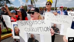 A crowd protests outside the Broward County supervisor of elections office, Nov. 9, 2018, in Lauderhill, Fla. 