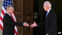 FILE - President Joe Biden, right, and Russian President Vladimir Putin arrive to meet at the 'Villa la Grange', in Geneva, Switzerland, June 16, 2021. 