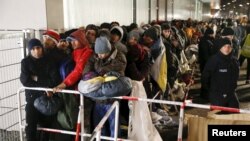 Migrants queue on a street to enter the compound outside the Berlin Office of Health and Social Affairs (LAGESO) for their registration process in Berlin, Germany, Dec. 9, 2015. Chancellor Angela Merkel's Bavarian allies want to ban migrants from entering Germany unless they have valid identity papers, a draft document from the Christian Social Union (CSU) showed on Dec. 30.