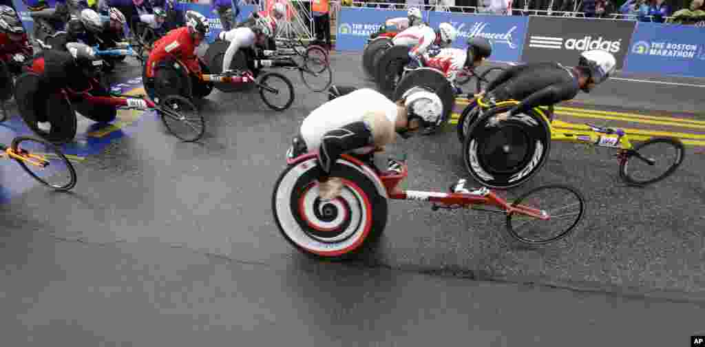 Ernst Van Dyk, foreground, of South Africa, leads the start of the wheelchair division of the Boston Marathon, in Hopkinton, MA, April 20, 2015.