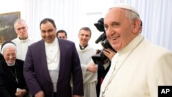 FILE - In this photo provided by the Vatican newspaper, Pope Francis smiles during an event at the Vatican on Jan.21, 2014. 
