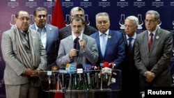 Morocco's new Prime Minister Saad Eddine El Othmani, center, gives a news conference next to Driss Lachgar, left, of the Socialist Union of Popular Forces party (USFP), Aziz Akhannouch, second left, of the National Rally of Independents (RNI), Mohamed Nabil Benabdallah, third right, of the Progress and Socialism party (PPS), Mohammed Sajid, second right, of the Constitutional Union (UC) party, and Mohand Laenser, right, of the Popular Movement, in Rabat, Morocco, March 25, 2017.