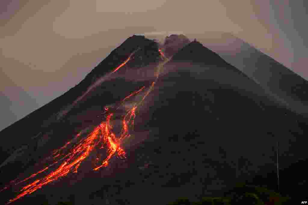 Lava flows down from the crater of Mount Merapi, Indonesia&rsquo;s most active volcano, as seen from Kaliurang in Yogyakarta.