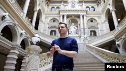 FILE - Austrian data activist Max Schrems stands in the courthouse after his trial against Facebook in Vienna, April 9, 2015. 