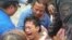 Police and rescuers comfort a crying passenger after he was brought ashore from a capsized passenger ferry July 2, 2015, in Ormoc city, central Philippines. 