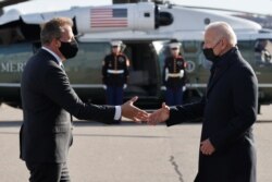 New Hampshire Governor Chris Sununu greets U.S. President Joe Biden as he arrives at Manchester-Boston Regional Airport in Manchester, New Hampshire, November 16, 2021.